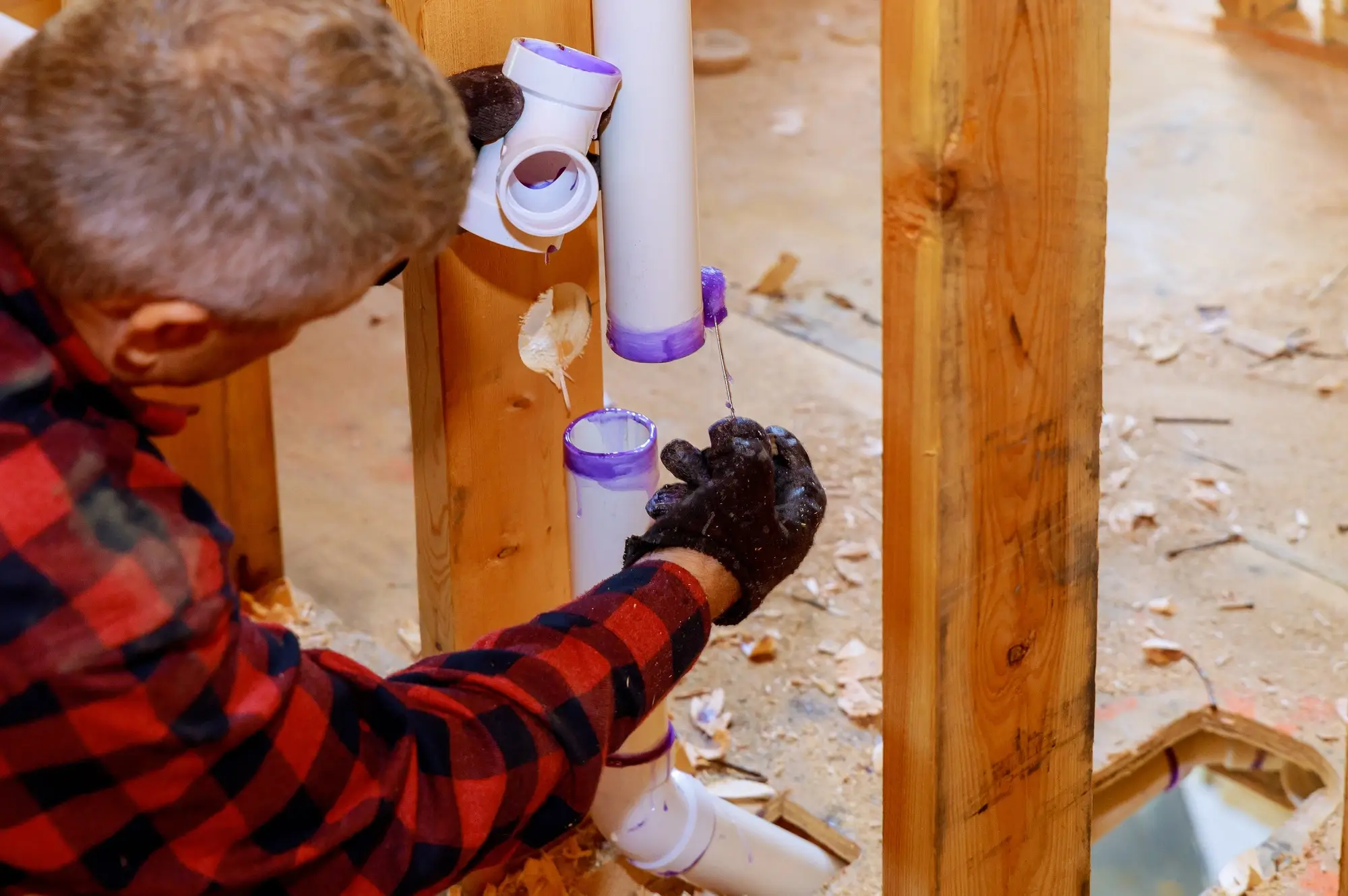 Plumber assembling pvc drain pipes