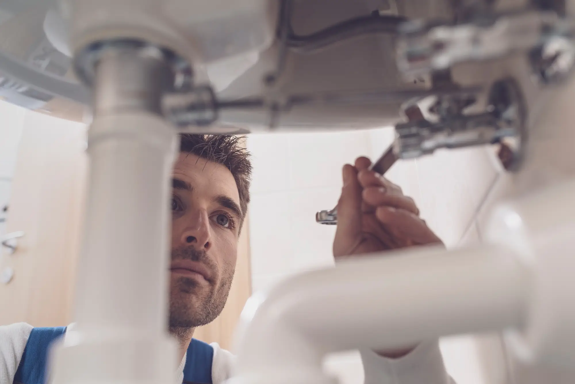 Plumber fixing a sink at home